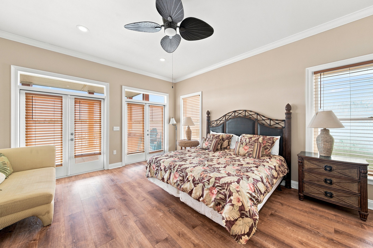 Bedroom with plantation shutters and a ceiling fan