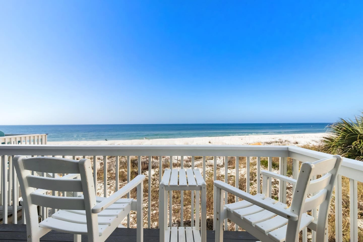Step onto the main-level beachfront deck the moment you arrive &mdash; the Gulf is right there, and the day's already better than anything back home.