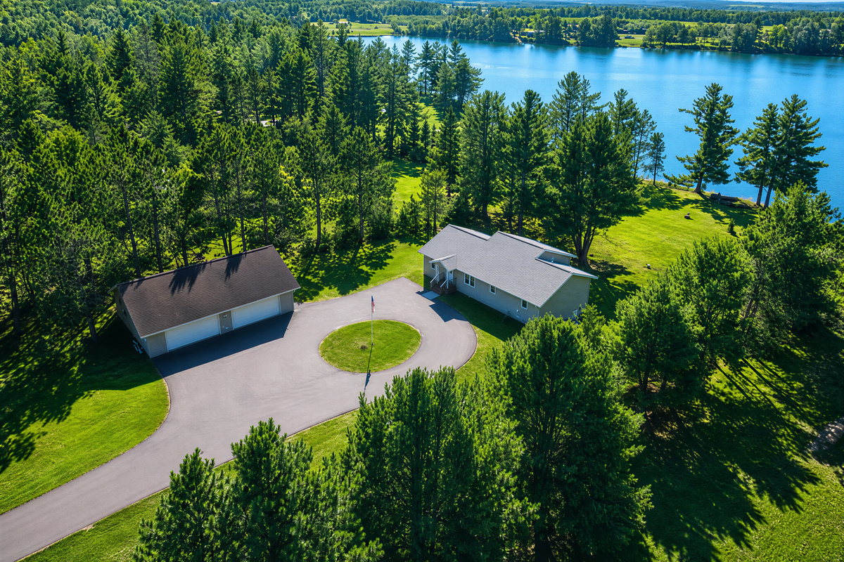 Private acreage with ample paved parking and 250 feet of west-facing shoreline on Windfall Lake