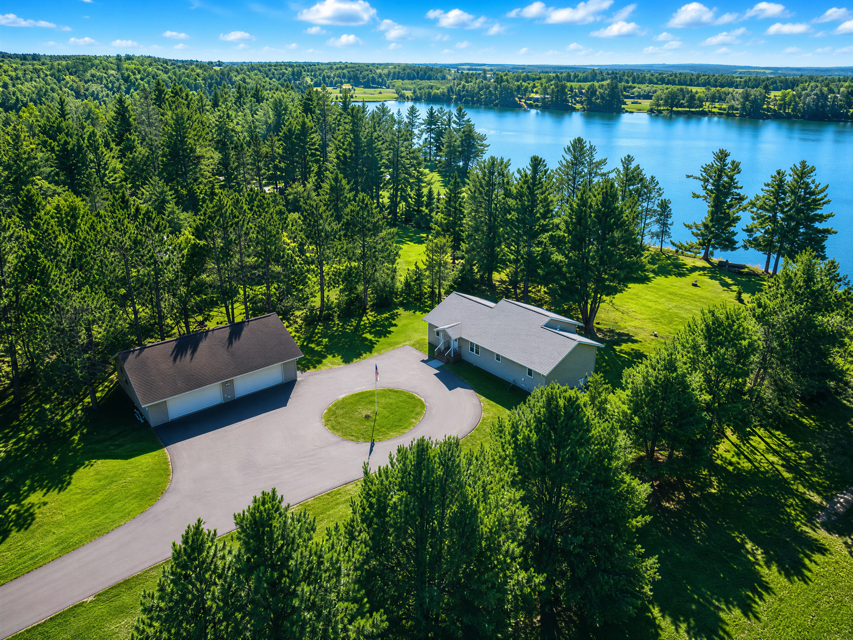 Private acreage with ample paved parking and 250 feet of west-facing shoreline on Windfall Lake
