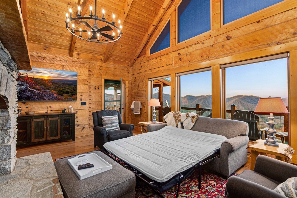 Living Room: Stunning mountain views from spacious windows and charming rustic decor!