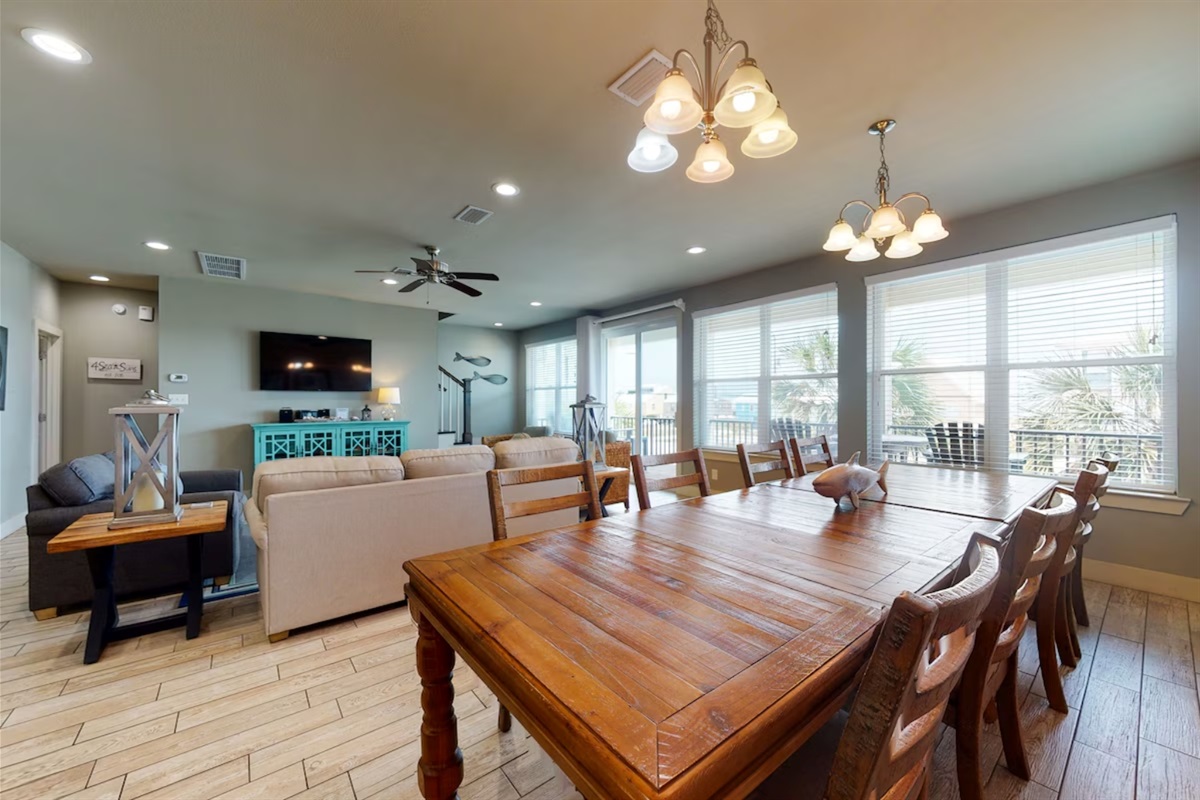 Dining area with a table and chairs set for 8 and additional seating for 4 at the breakfast bar 