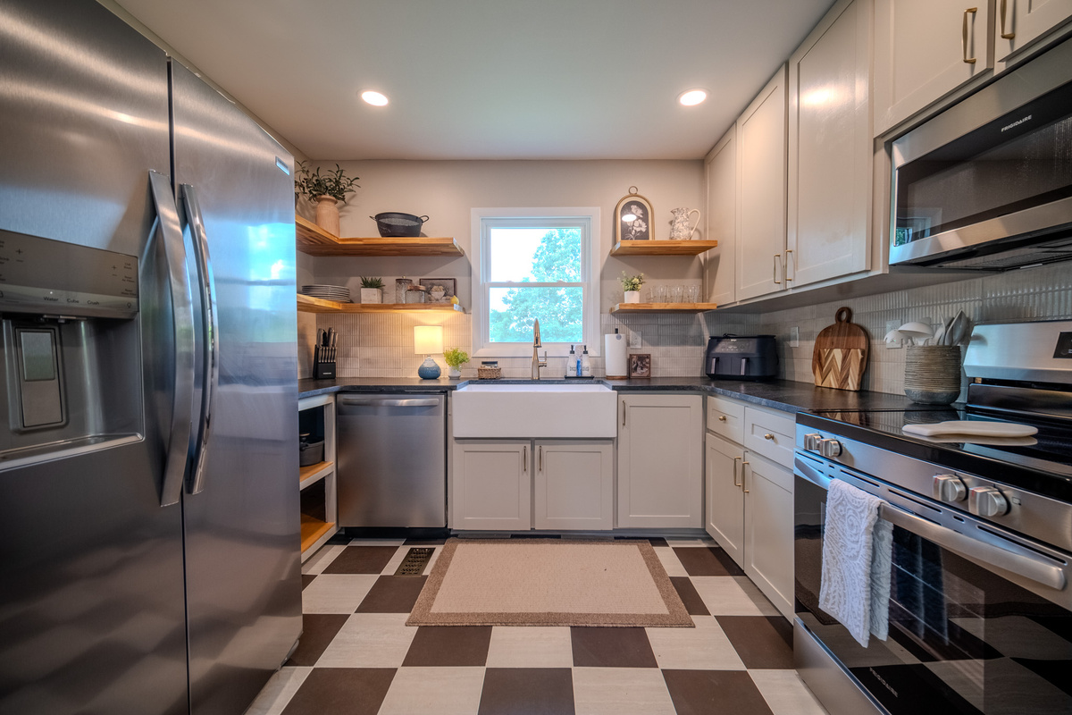 Bright, fully equipped kitchen with open shelving, modern appliances, and everything you need to prepare meals during your stay.