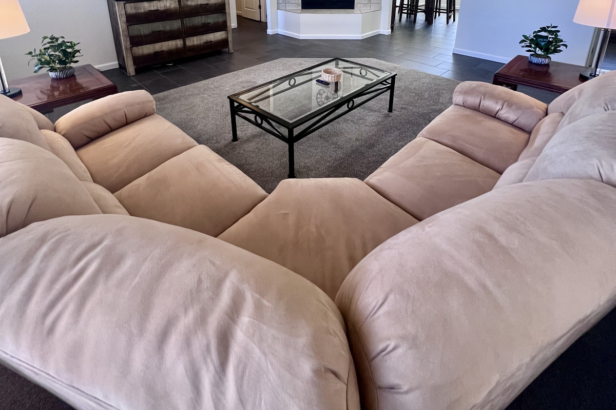 This expansive living room offers plenty of space for everyone to spread out and relax. Whether you're curling up by the fire with a good book, watching a movie on the  60-inch Smart TV, or enjoying game night with friends, this space has it all