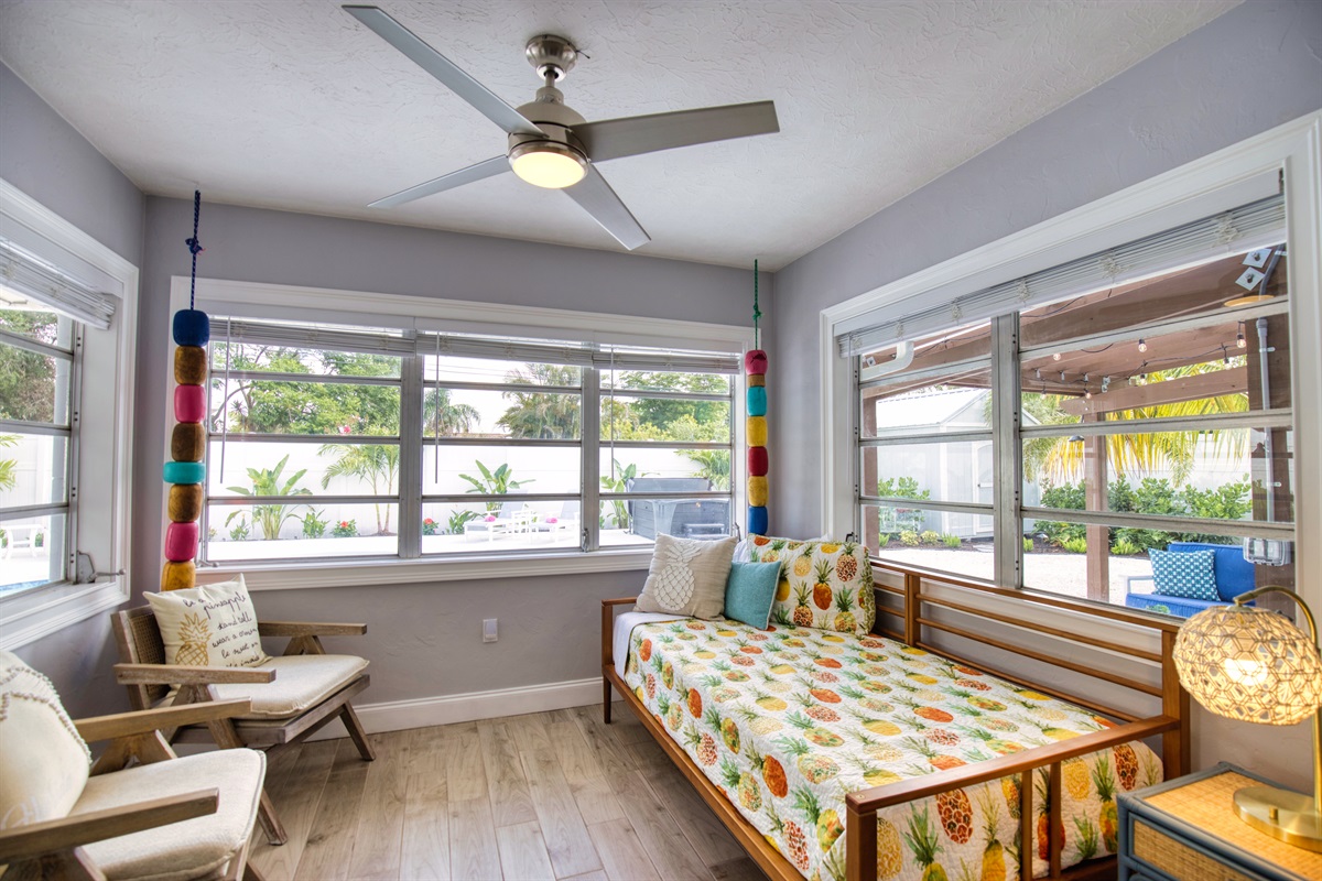 The THIRD room has a twin daybed with a nightstand, ceiling fan and 2 comfortable chairs.