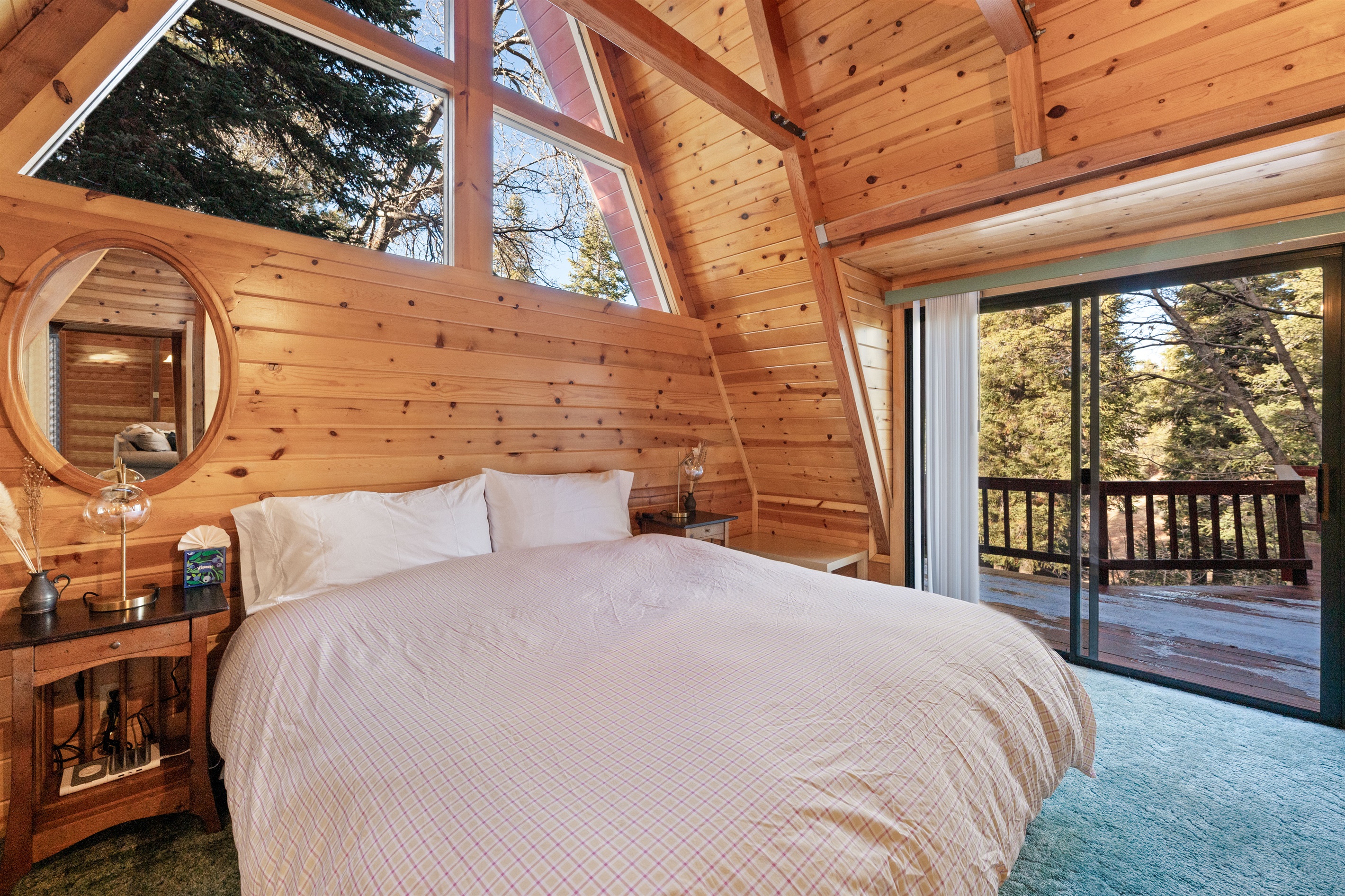 Master bedroom with vaulted ceilings and big windows