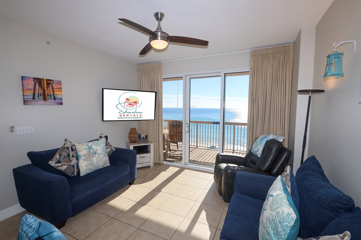 Relax after the beach with family or friends on the comfy queen sleeper sofa — Smart TV and bright coastal décor included