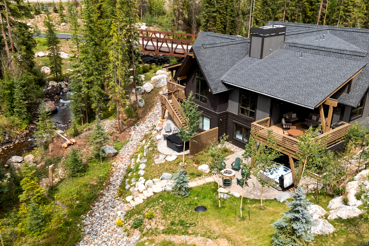 Summer exterior of Riverside Escape with Blue River and the bridge over the river that leads into this exclusive neighborhood with no through traffic. 