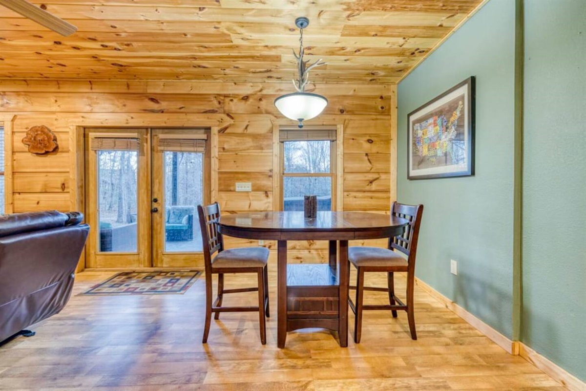 Enjoy a cozy table and chairs near the wet bar, ideal for board games or card games.