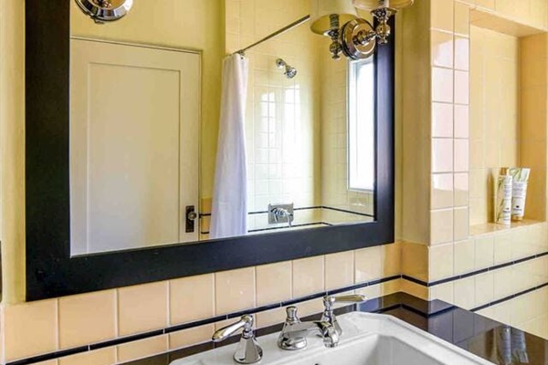 Sink cabinet with large vanity mirror and storage.  
