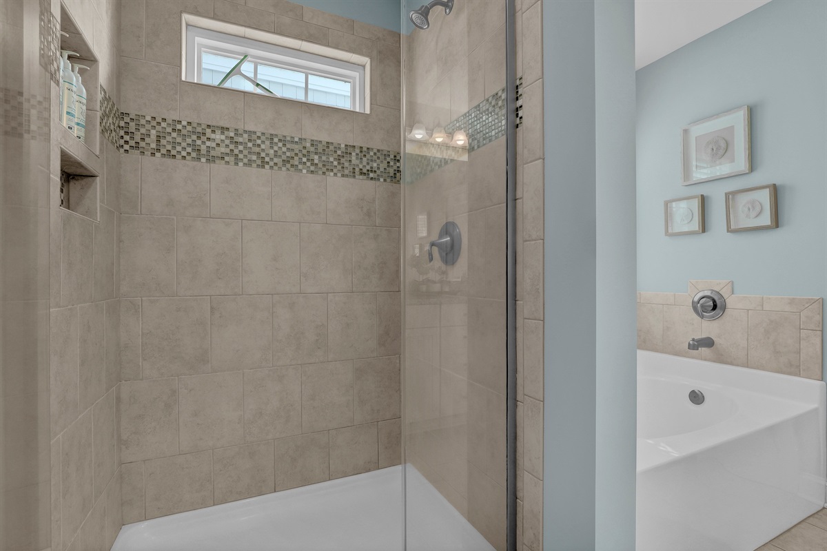 A spacious, modern walk-in shower featured in the primary suite.