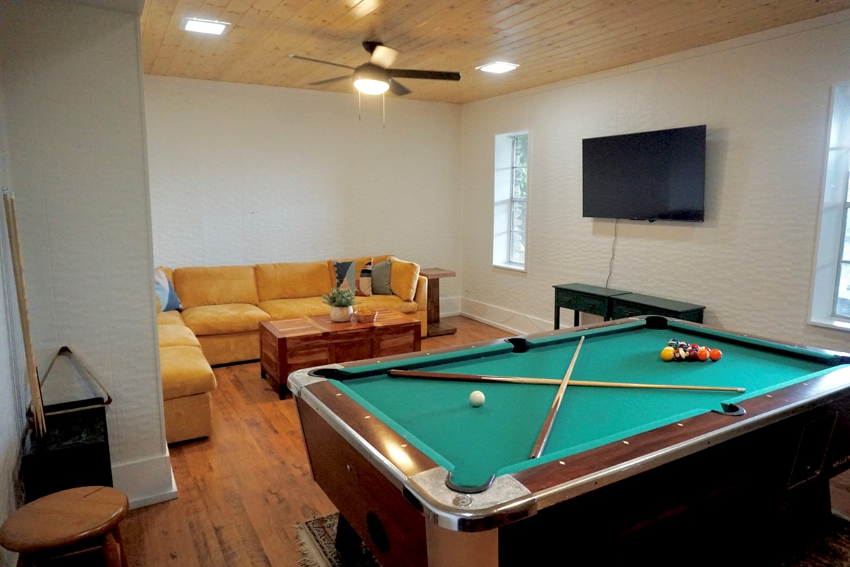 Play pool and unwind in this vibrant space with a comfy sectional and TV!