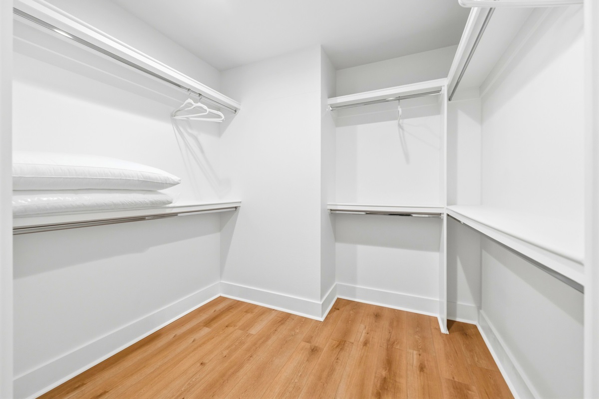 Generous shelving and hanging space in the walk-in closet make it easy to keep belongings organized during your stay.