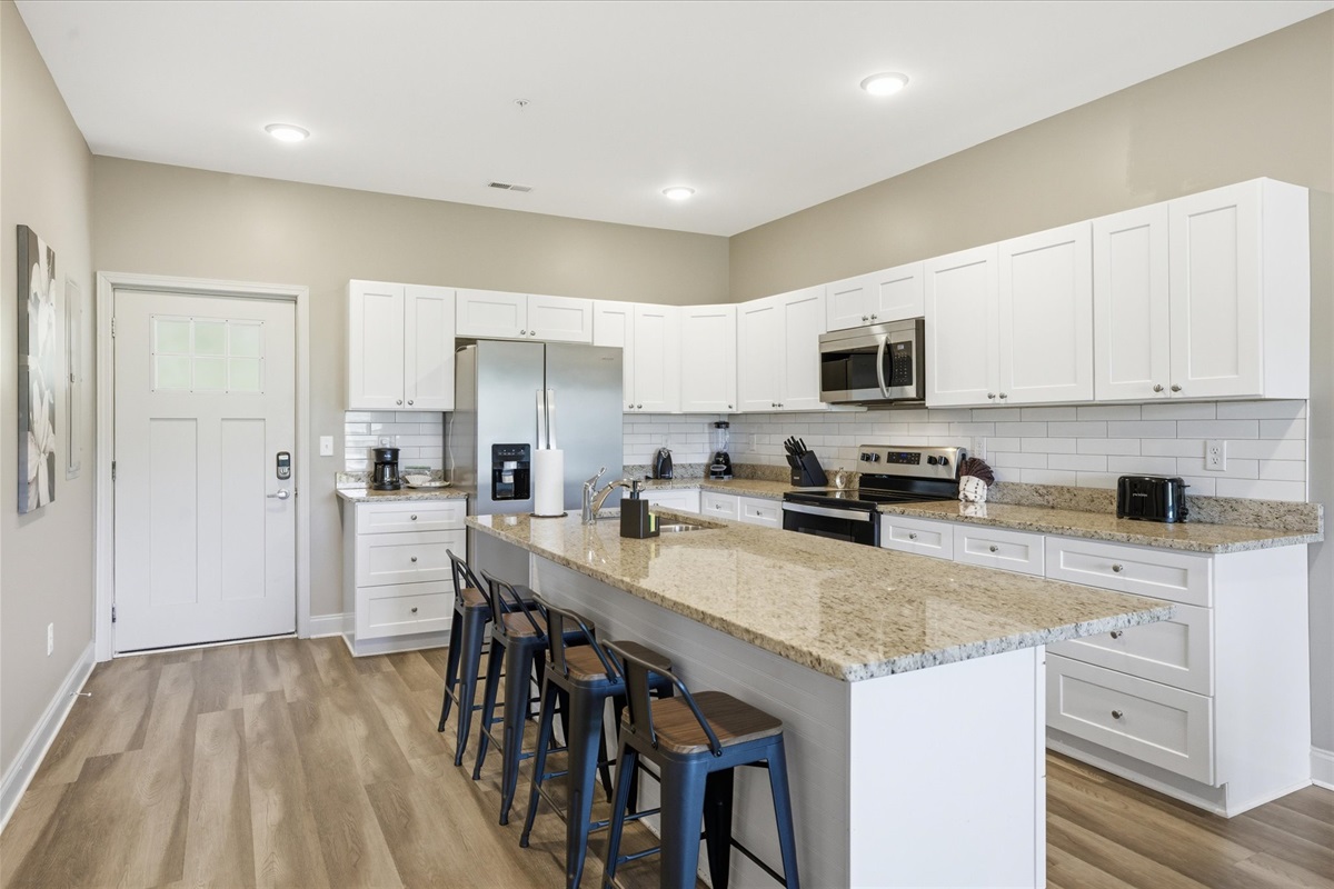 As you walk into Unit 4, the layout opens up right away—kitchen ahead, living space beyond, and everything easy to take in from the start.