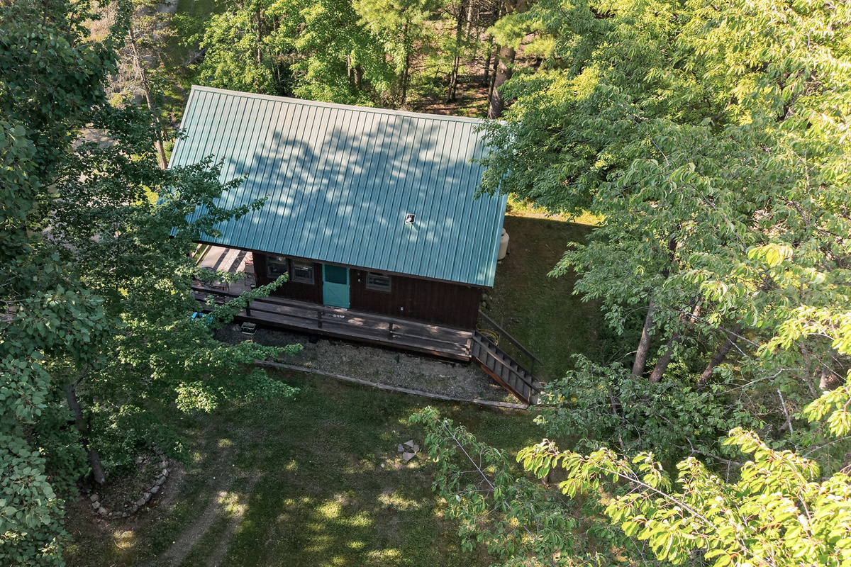 Rear exterior surrounded by woods