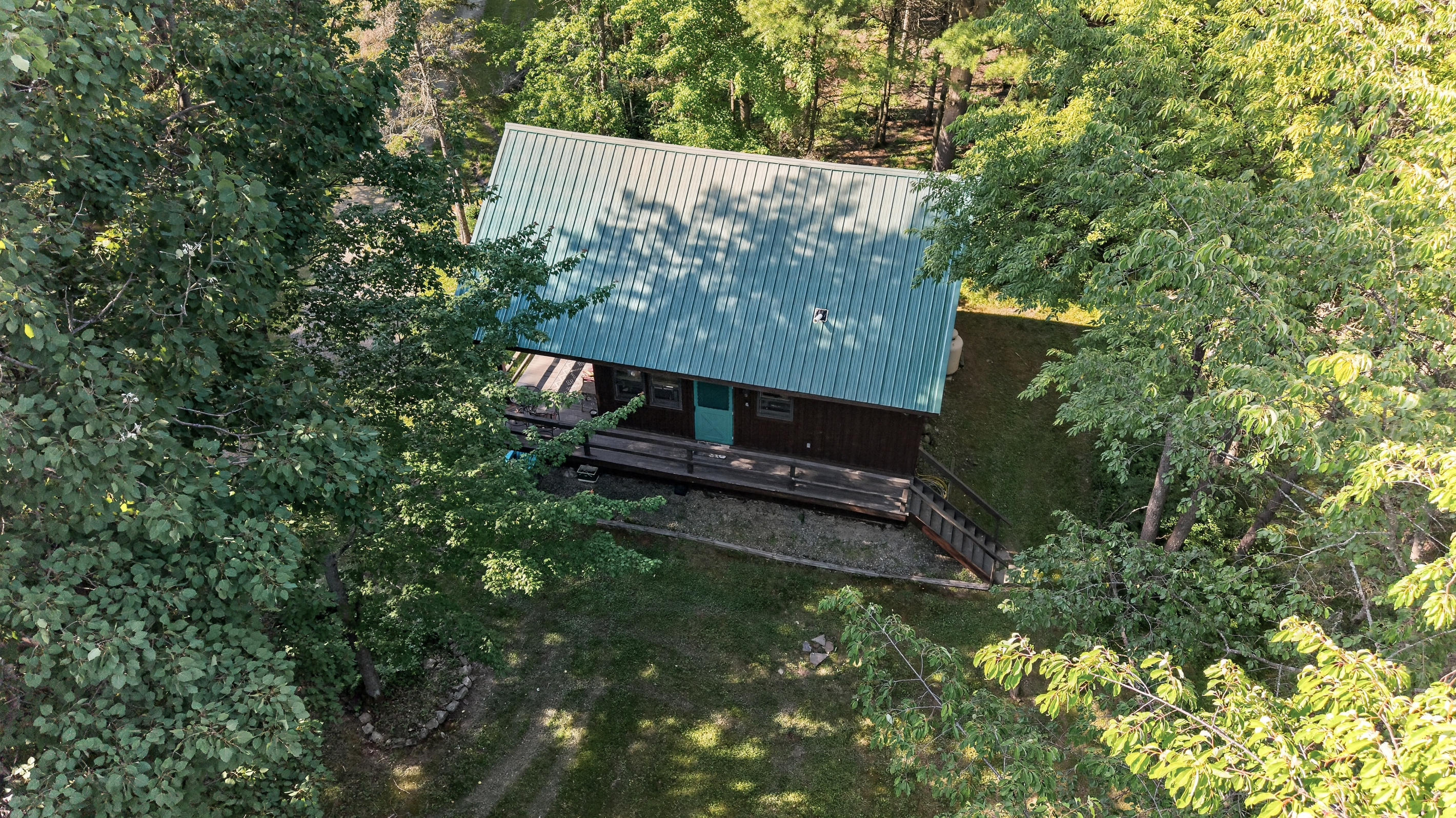 Rear exterior surrounded by woods