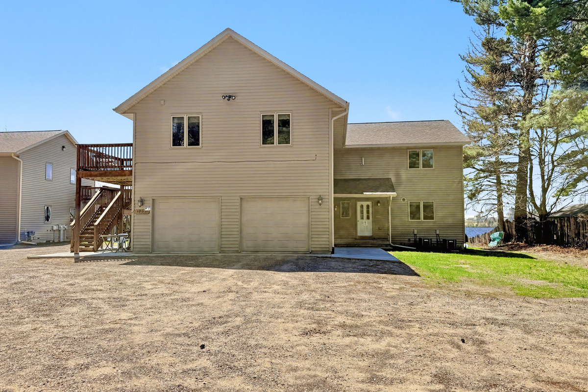 Exterior - Front of Duplex with Driveway and Garage