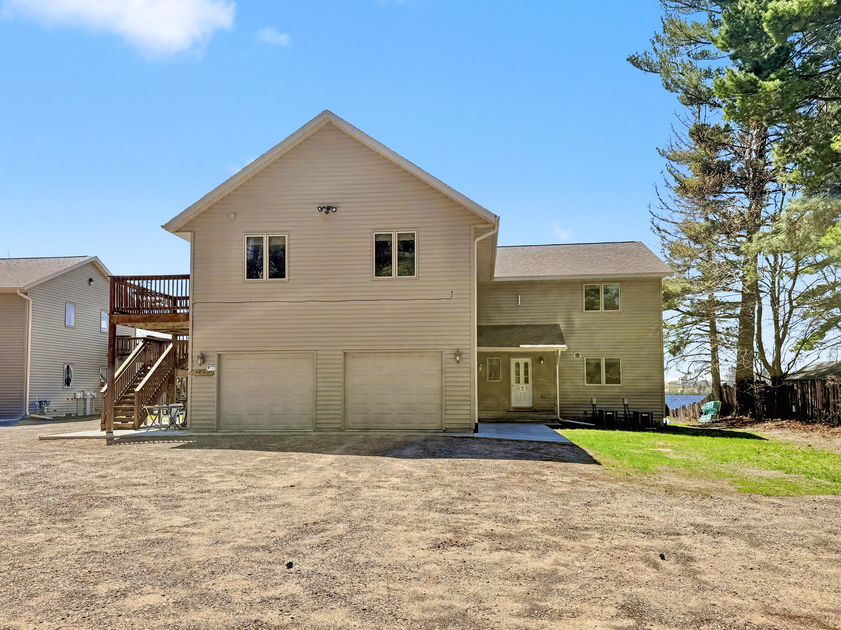 Exterior - Front of Duplex with Driveway and Garage