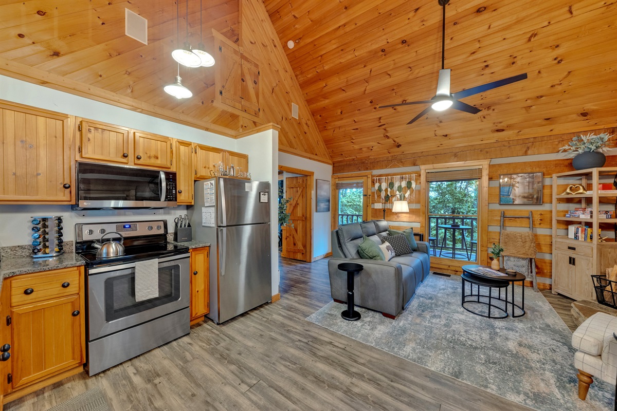 Stainless steel appliances and custom wood cabinetry pair beautifully with the cabin’s charm
