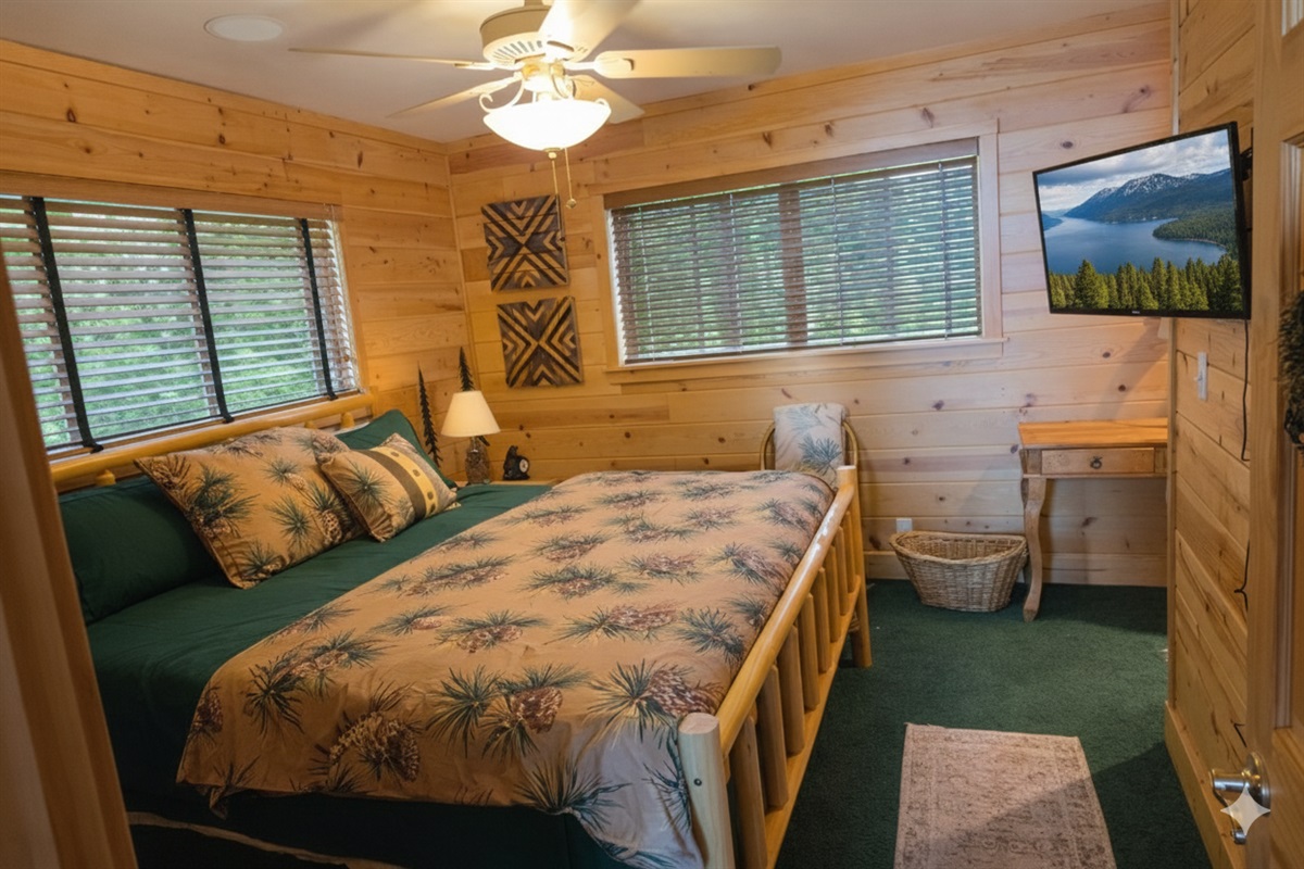 This bedroom is the closest to the front door.  It has an ensuite bathroom with shower, toilet, sink and storage.  It also has a king size bed, closet, tv, dresser and nightstands with lamps.
