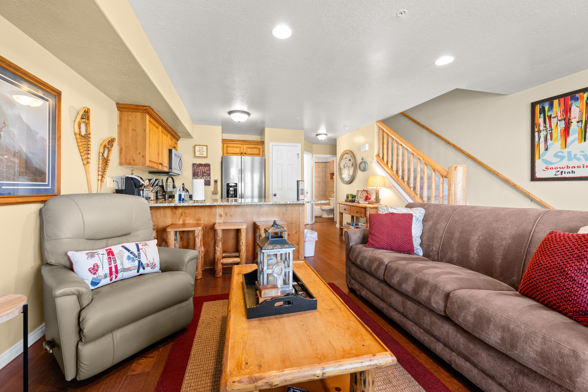 The living room, freshly appointed with new furniture, offers easy access to the outdoor deck.