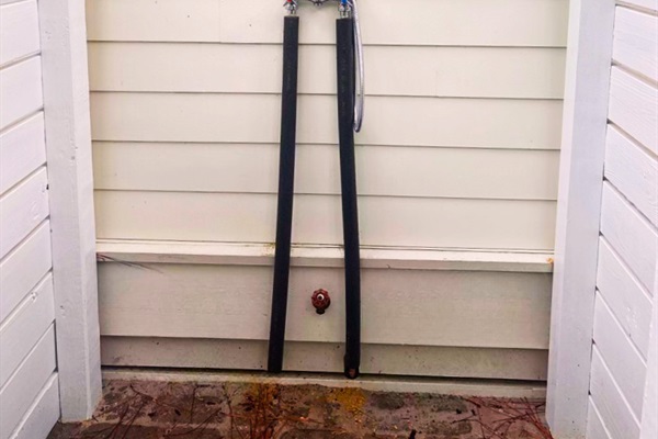 Enjoy an outdoor shower with hot & cold water and a pavered floor.