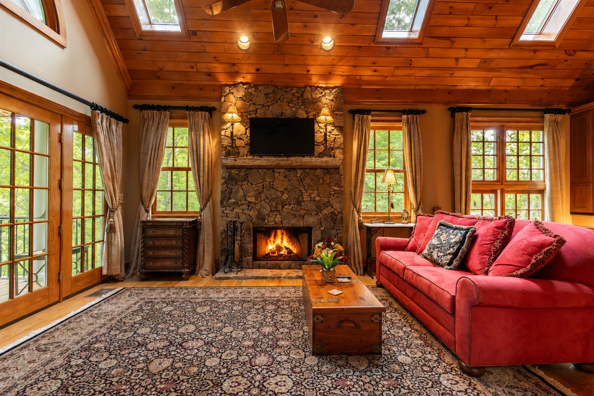 Curl up by the glowing wood-burning fireplace while enjoying the beauty of the vaulted ceilings and large windows that bring the outdoors in.