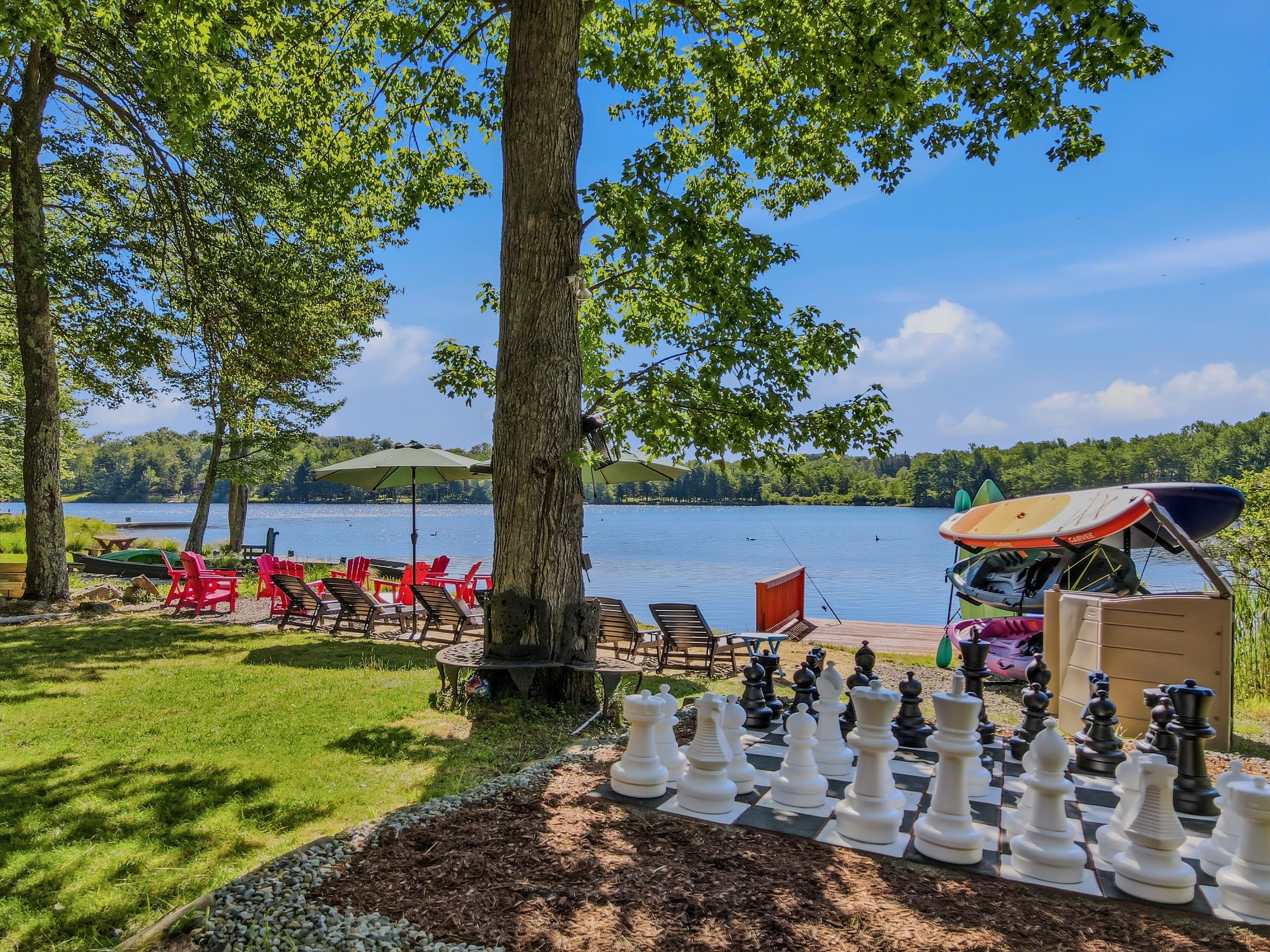 Lakefront lawn with giant chess set, lounge chairs, and direct access to Lake Carobeth