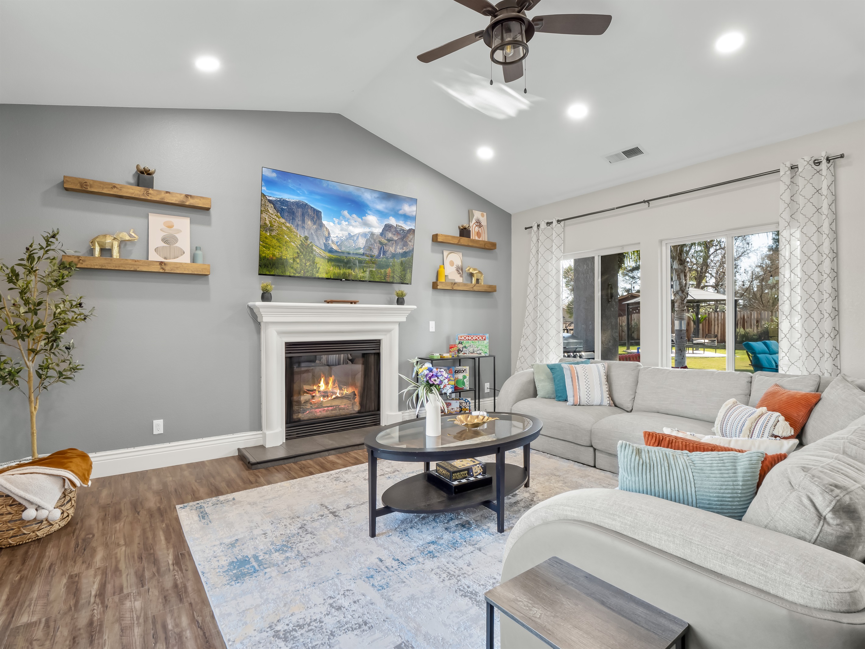 Spacious and welcoming living area with a cozy fireplace, large smart TV, and comfortable sectional seating—perfect for movie nights, board games, and quality time together.