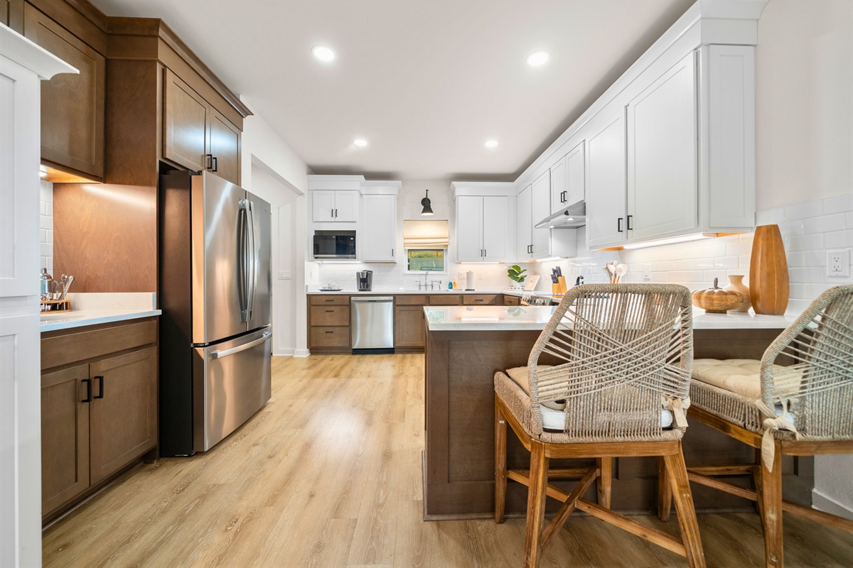 Open-concept kitchen and dining area with stainless appliances.