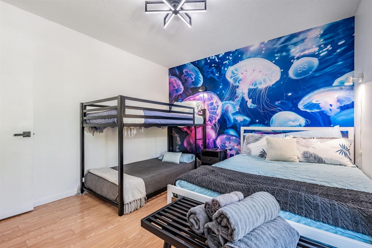 Third bedroom with three beds. A fun room with a bunked and something magical hiding in the closet.