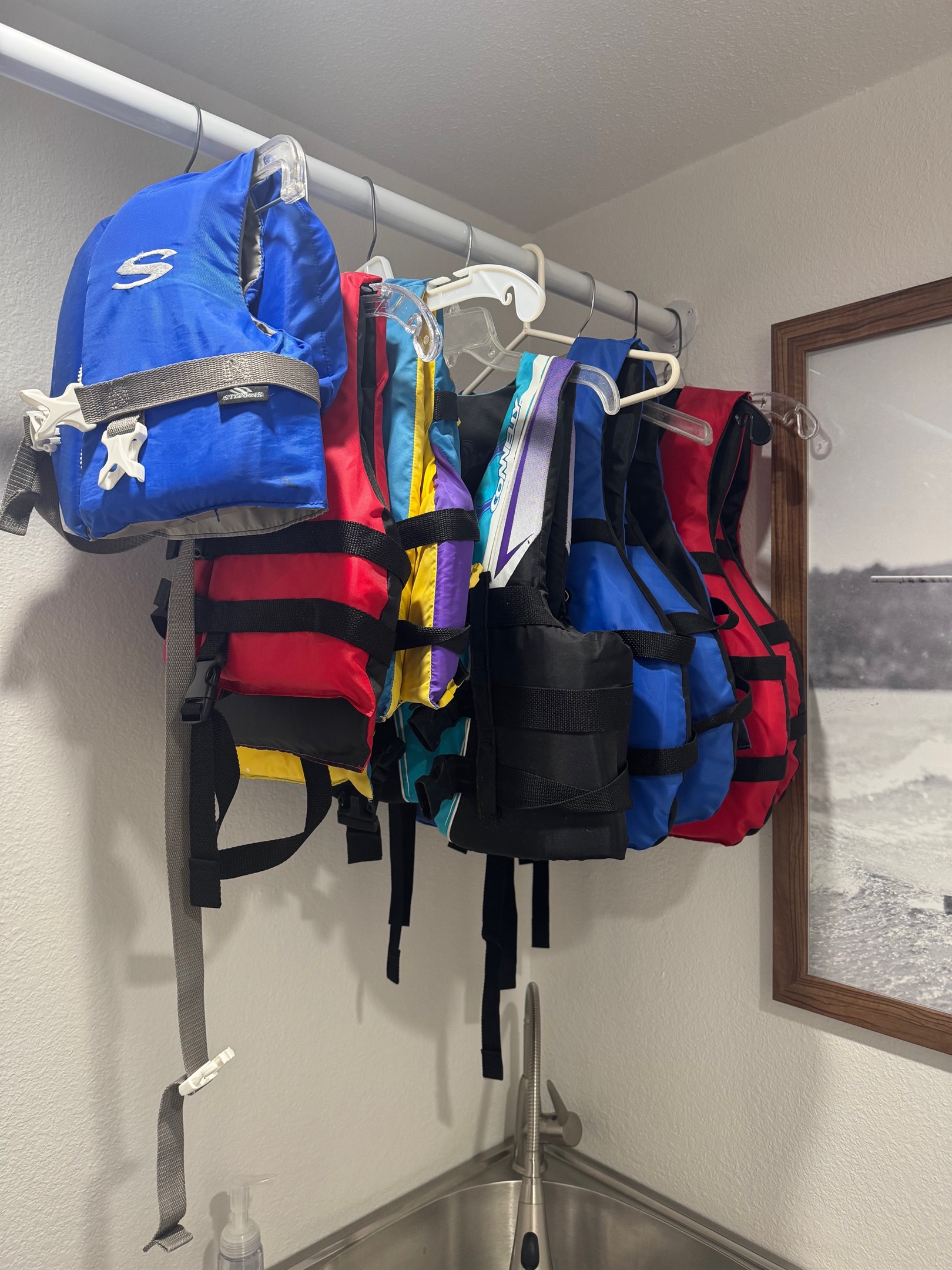 8 lifejackets of various sizes in laundry room