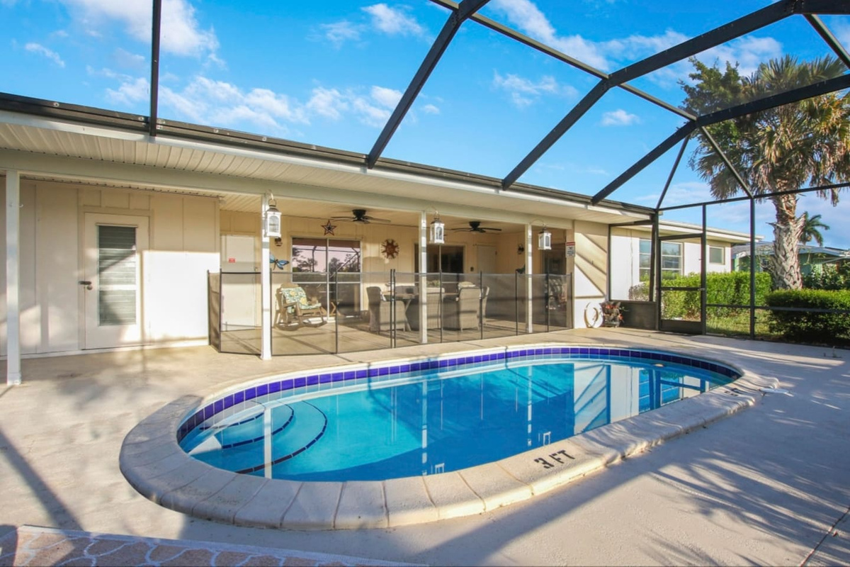 Private screened in pool area. The large open screen keeps the Florida bugs at bay while still allowing for you to get some sun. There is also a safety gate provided that can be set up to keep any young non swimming guests safe.