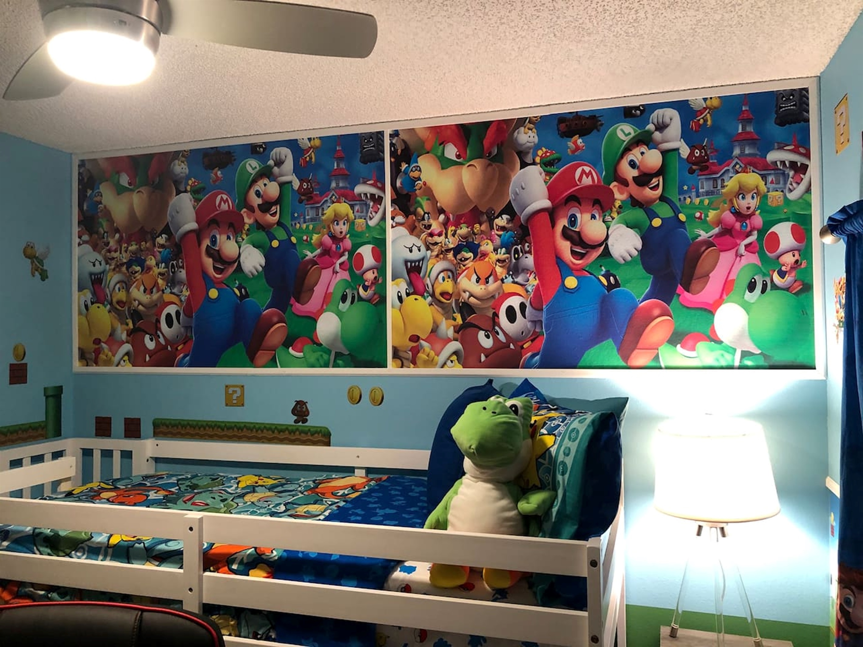 Twin bunkbed room , a playful children's bedroom featuring a Mario themed wall mural and bedding.