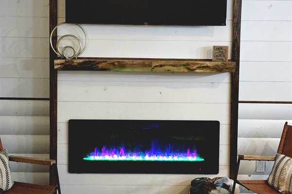 Look at that amazing fireplace! Heat on or off. Your choice but the different colors are fun to watch. Includes brand new 55" Smart TV.