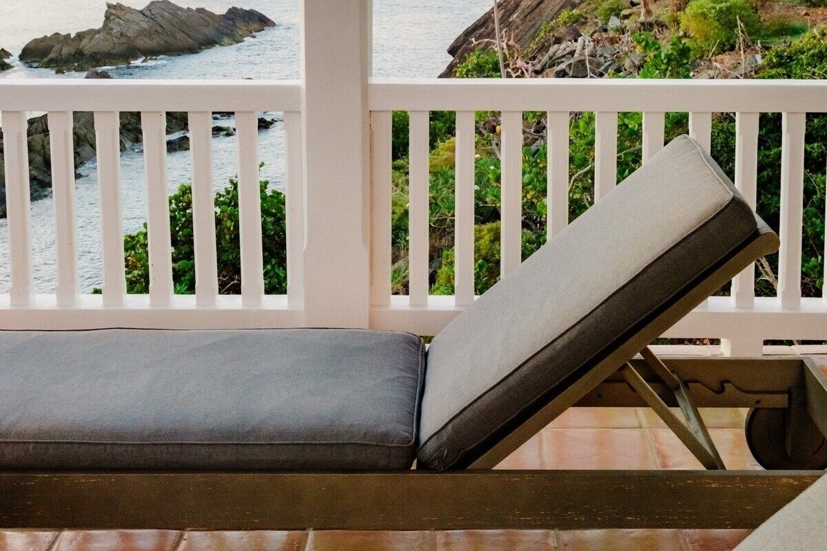 The rocks below the property that the waves break against.
