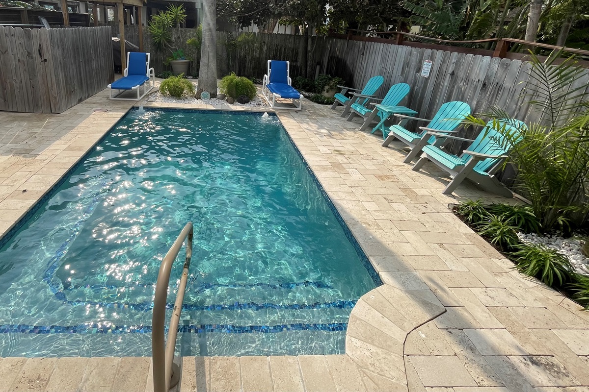 Private heated pool with loungers and seating area