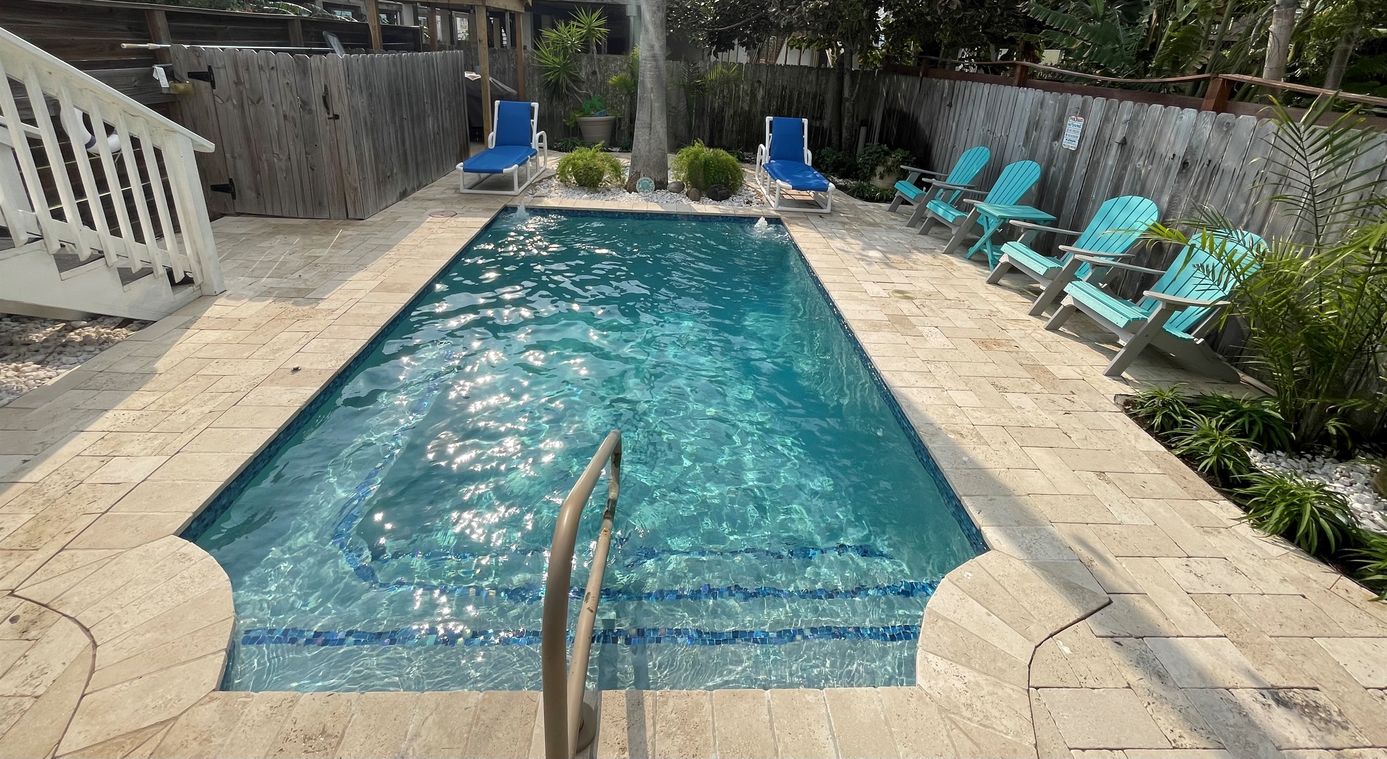 Private heated pool with loungers and seating area