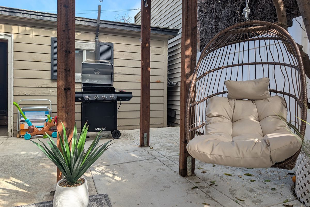 🌿 Your private outdoor retreat awaits. Sip your morning coffee, fire up the grill, or unwind in the cozy hanging chair after a day at the beach.