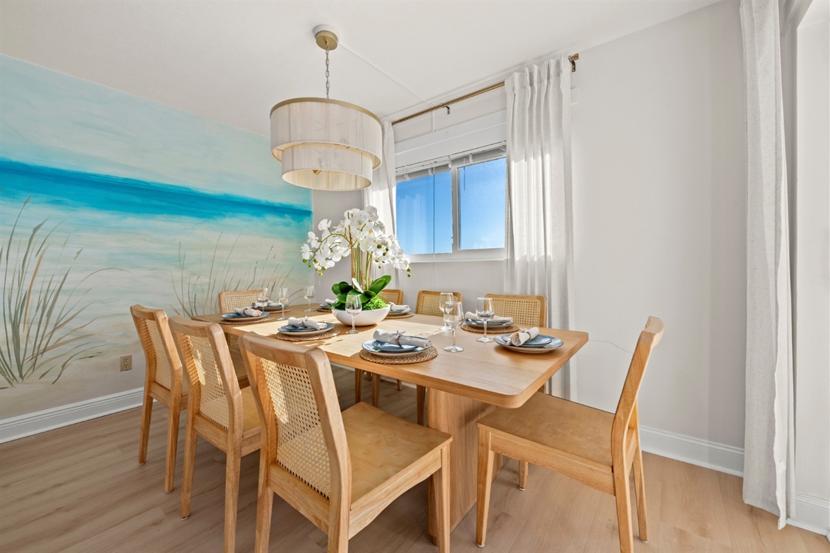 Enjoy unhurried meals in this sun-drenched dining space, where soft coastal tones and warm wood textures enhance your beach retreat.