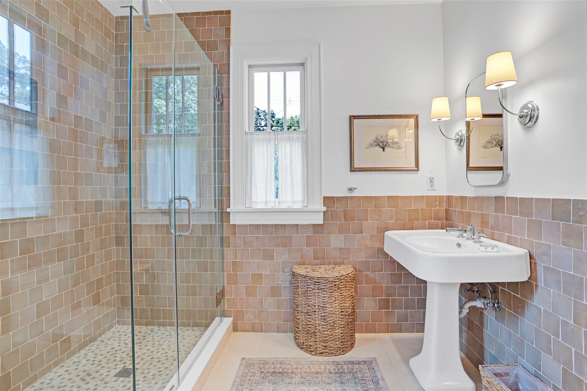 Enjoy the tranquility of a modern walk-in shower and sleek finishes designed for relaxation.