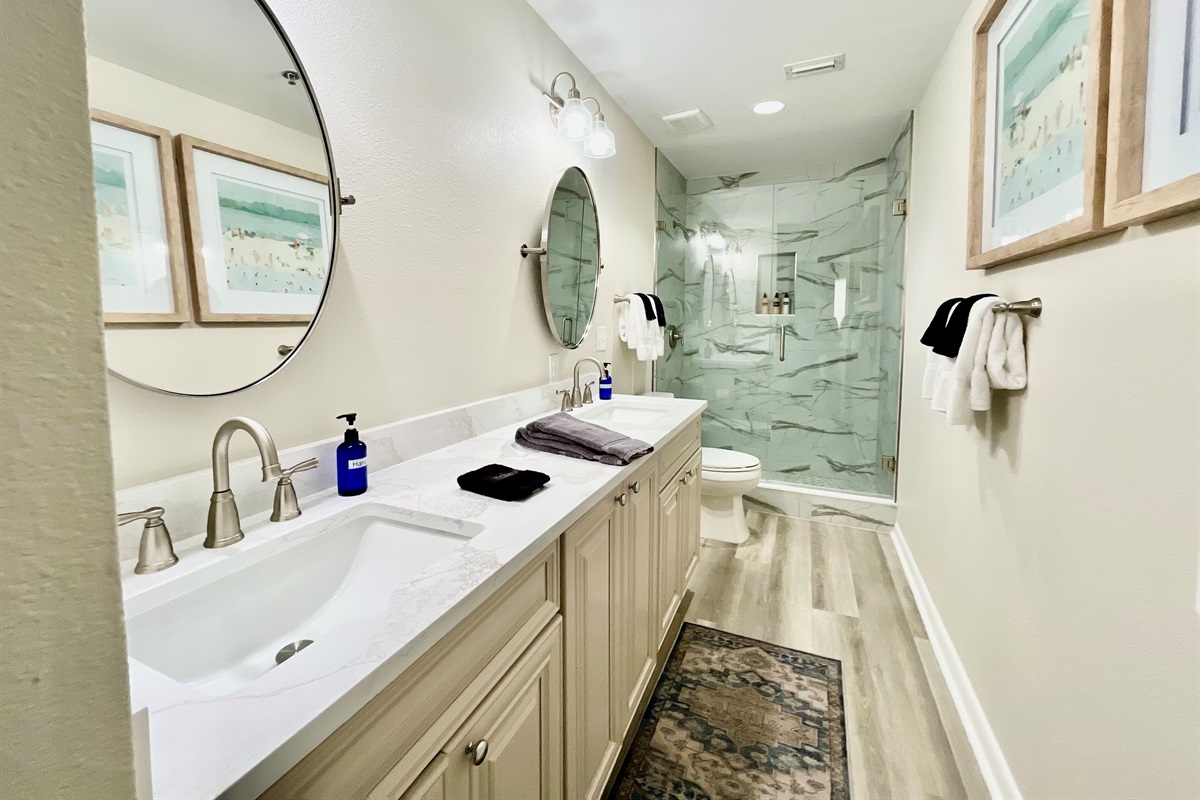 Newly renovated master bath with a double vanity and walk-in shower.