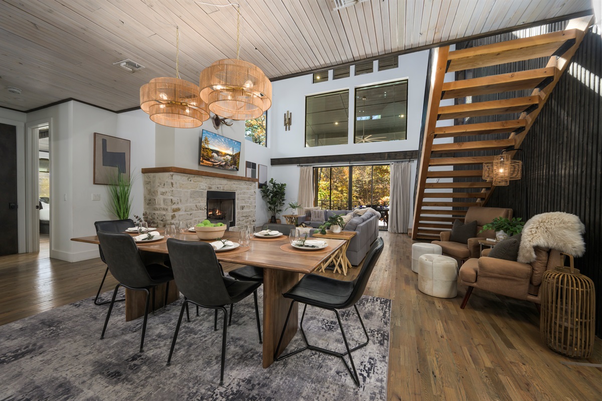 Experience luxury cabin living in Hochatown with vaulted ceilings, modern design, and a cozy stone fireplace.