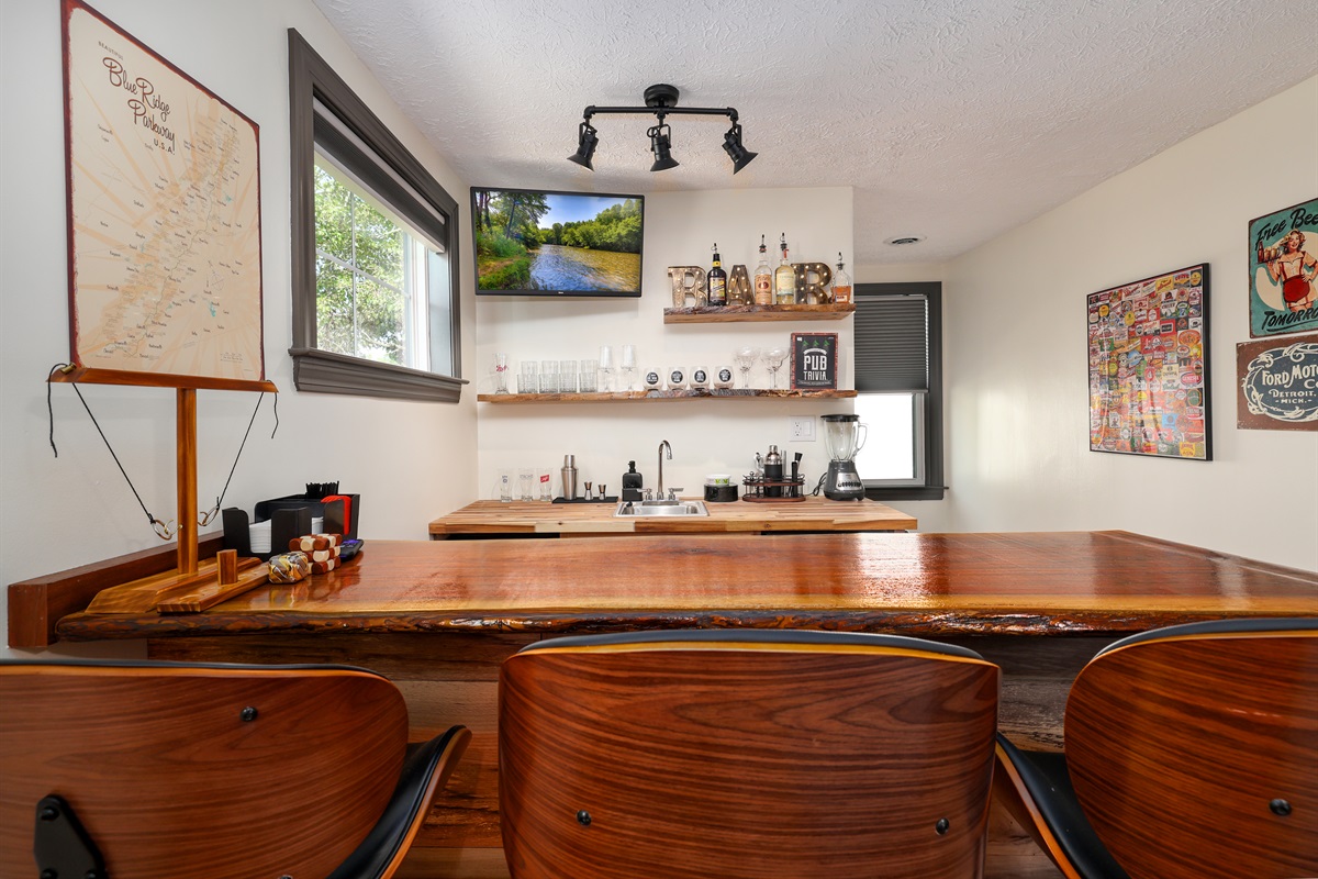 Full Bar with custom black walnut bar, seating, ice machine, sink, refrigerator, bar ware, glasses