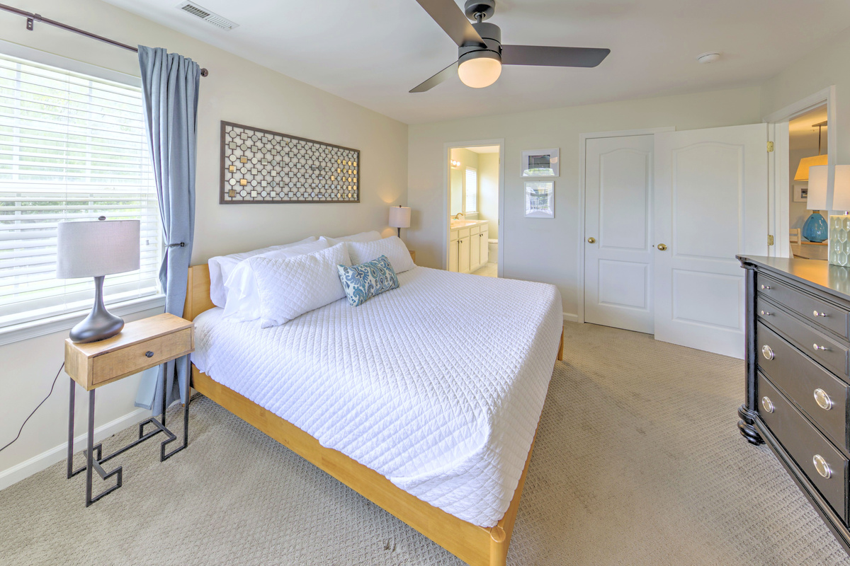Fresh linens provided and beds professionally made before arrival—no linen rentals required.

Primary Bedroom: Bright and airy retreat with a king bed, cheerful decor, and blackout curtains with an ensuite bathroom and large closet! Perfect for relaxation.