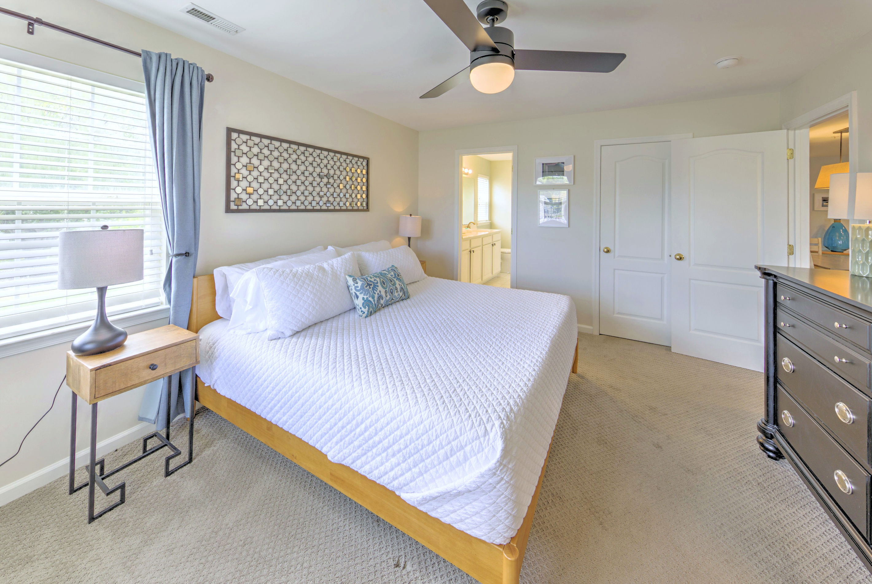 Fresh linens provided and beds professionally made before arrival—no linen rentals required.

Primary Bedroom: Bright and airy retreat with a king bed, cheerful decor, and blackout curtains with an ensuite bathroom and large closet! Perfect for relaxation.