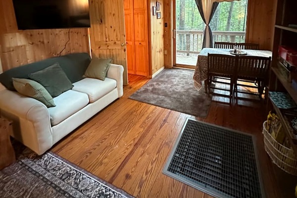 This couch pulls out into a twin-size bed, perfect for extra guests. Behind it, the wall-mounted smart TV extends and swivels, allowing you to adjust the viewing angle from anywhere in the room.