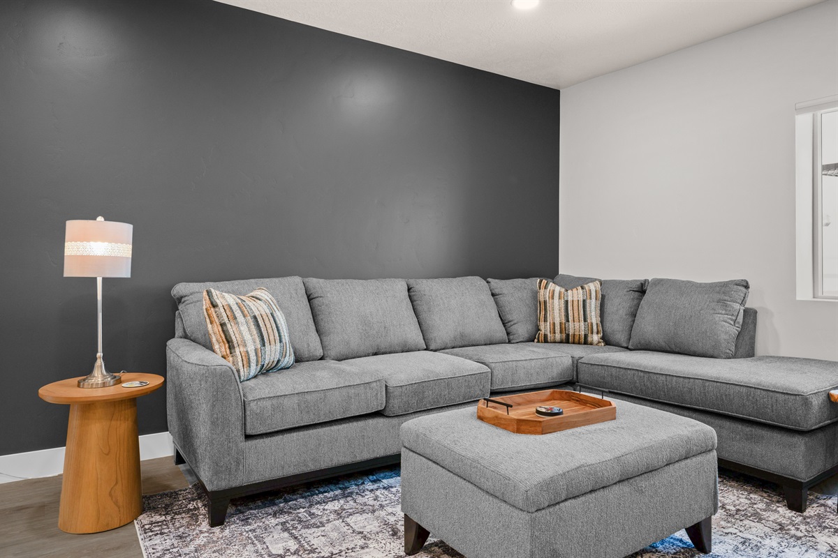 Modern living room with cozy sectional and chic accent wall.