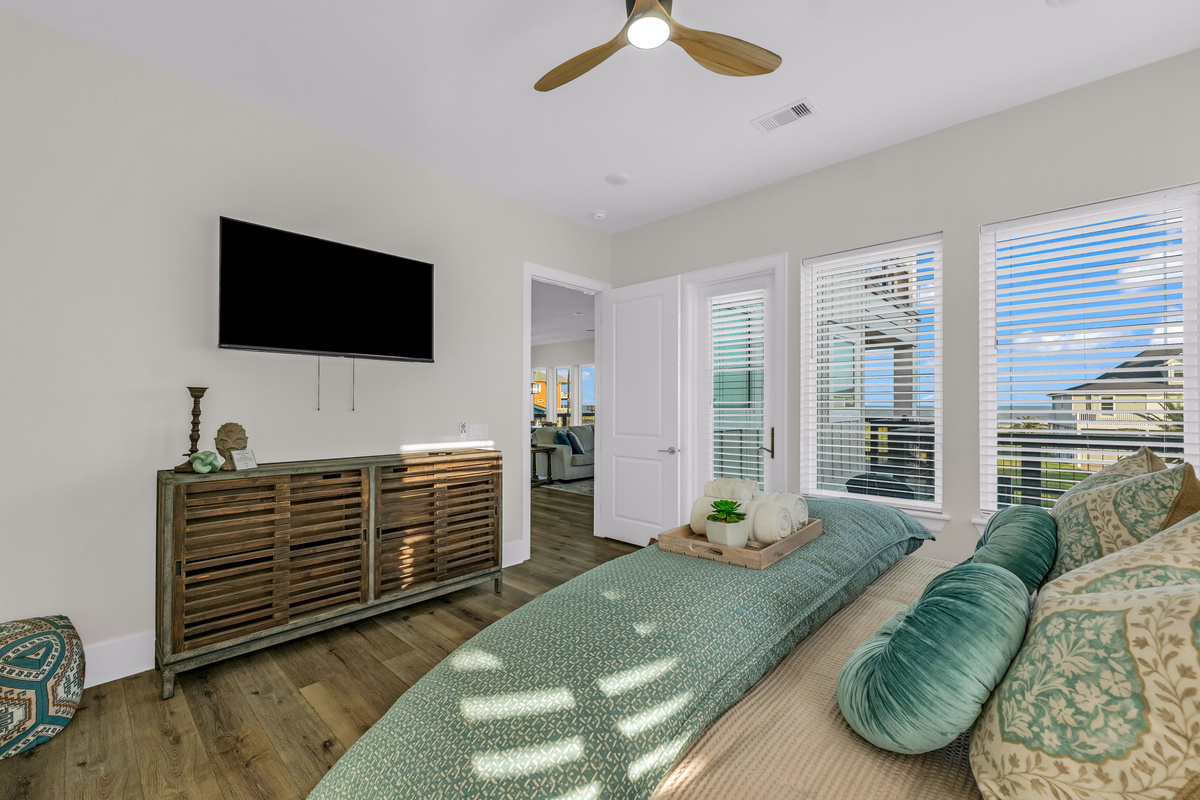 Costa Cristal Primary Bedroom: Unwind in a luxurious king bedroom, bathed in natural light and thoughtfully designed for comfort. Expansive windows frame breathtaking ocean views, creating a serene retreat.