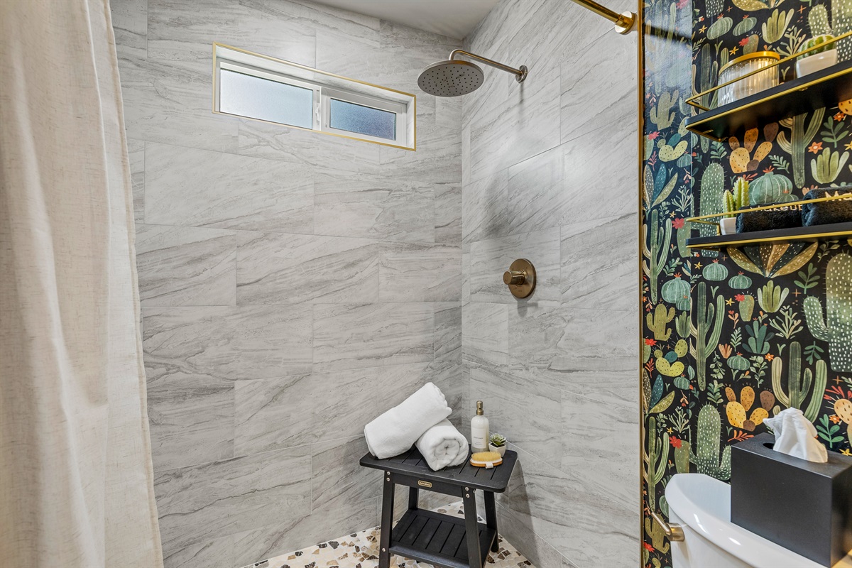 Step into the spacious walk-in shower and let the rainfall head melt your stress away - your personal retreat awaits.